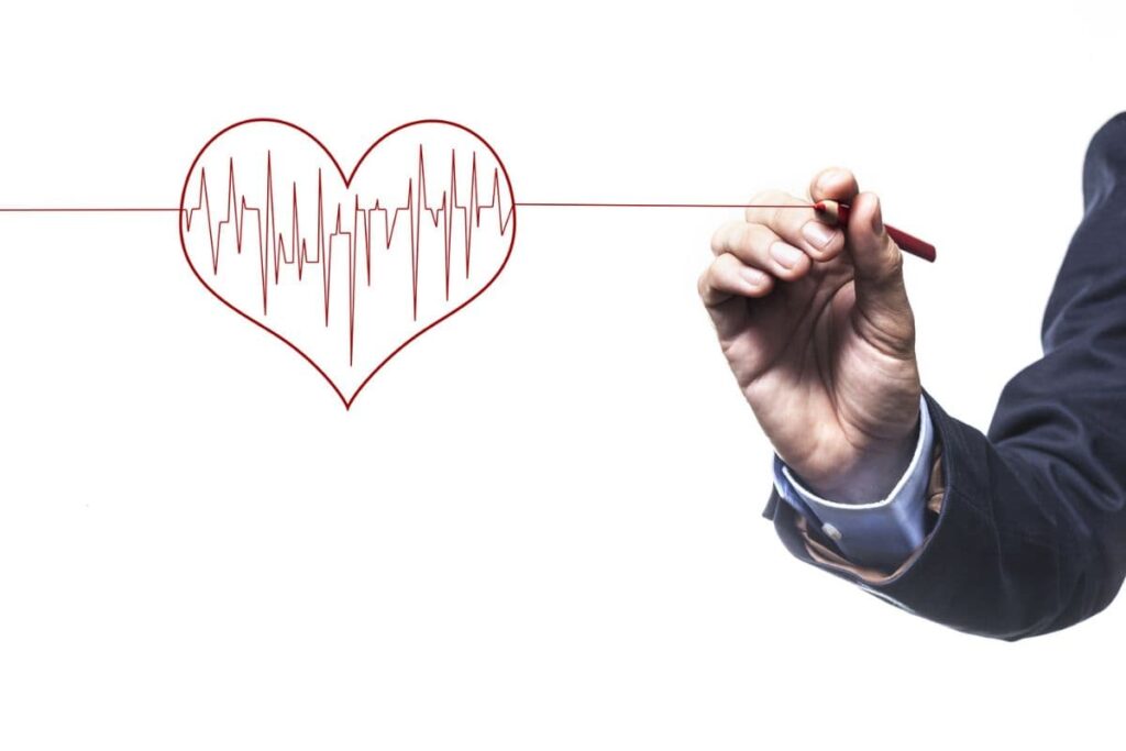 Hand drawing an EKG-style line inside a heart