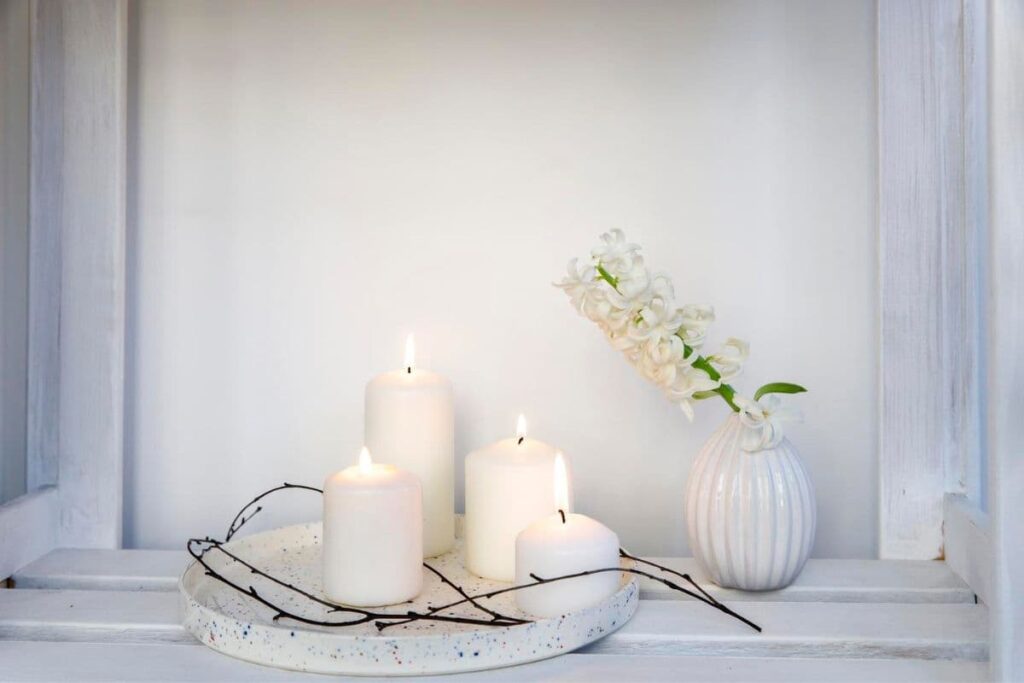 Three lit candles on countertop-environmental toxins may be making you sick
