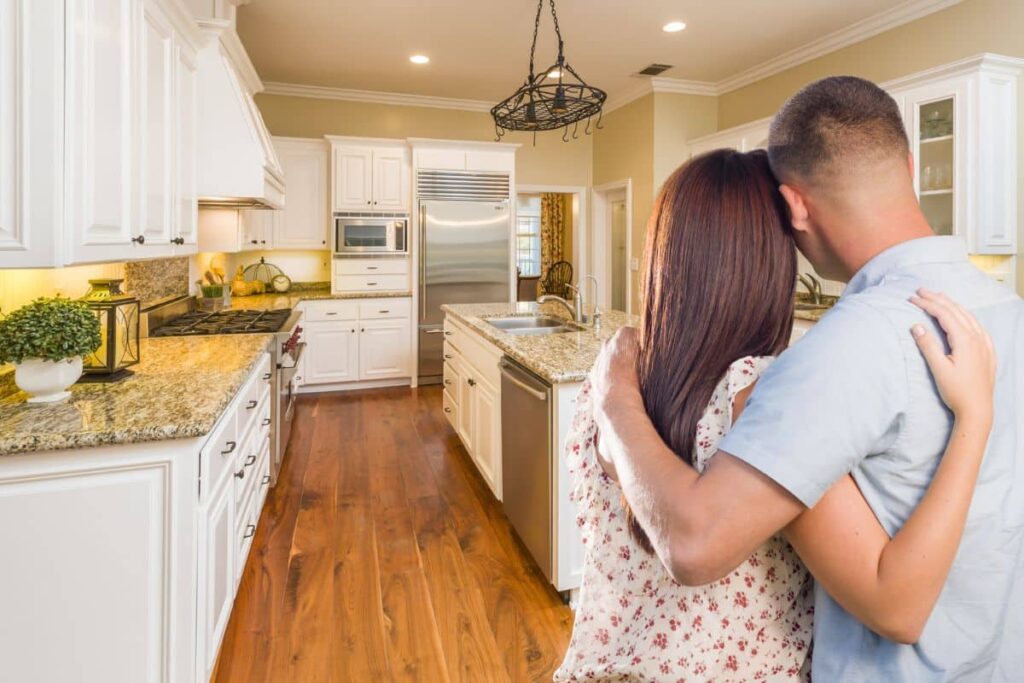 your hopeful couple looks at kitchen