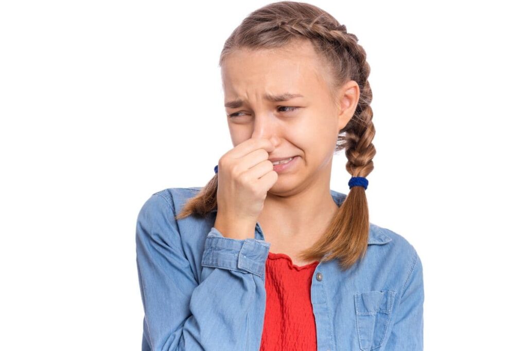 Girl holding her nose because something smells