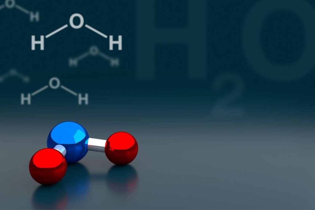 model of water molecule with writing: H-O-H