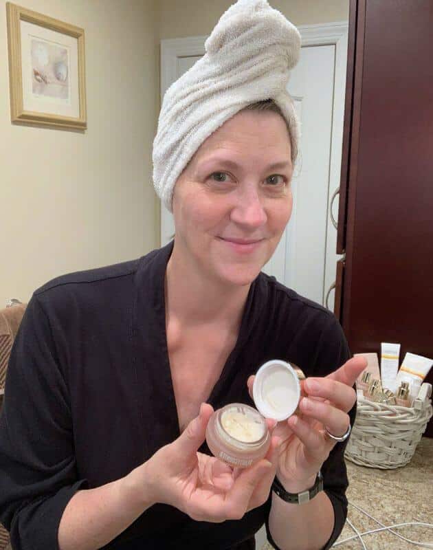Tina showing a jar of the Ultra Renewal Eye Cream.