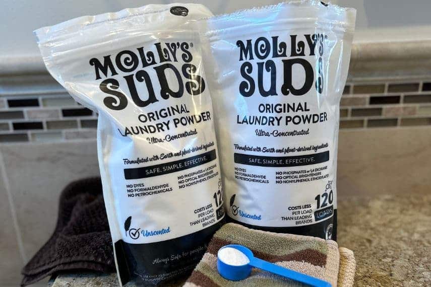 Molly's Suds-2 bags, scoop with powder, on washcloths.