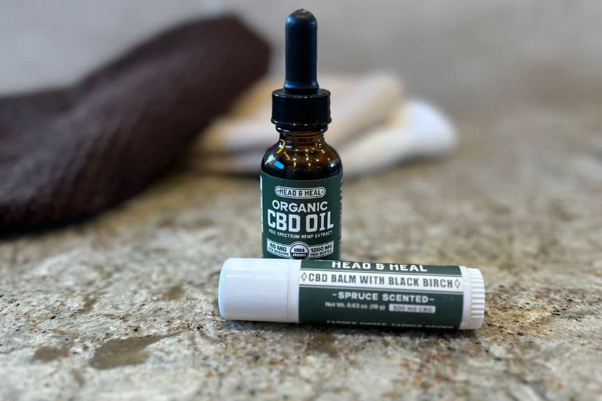 Head & heal CBD oil and CBD stick on counter.