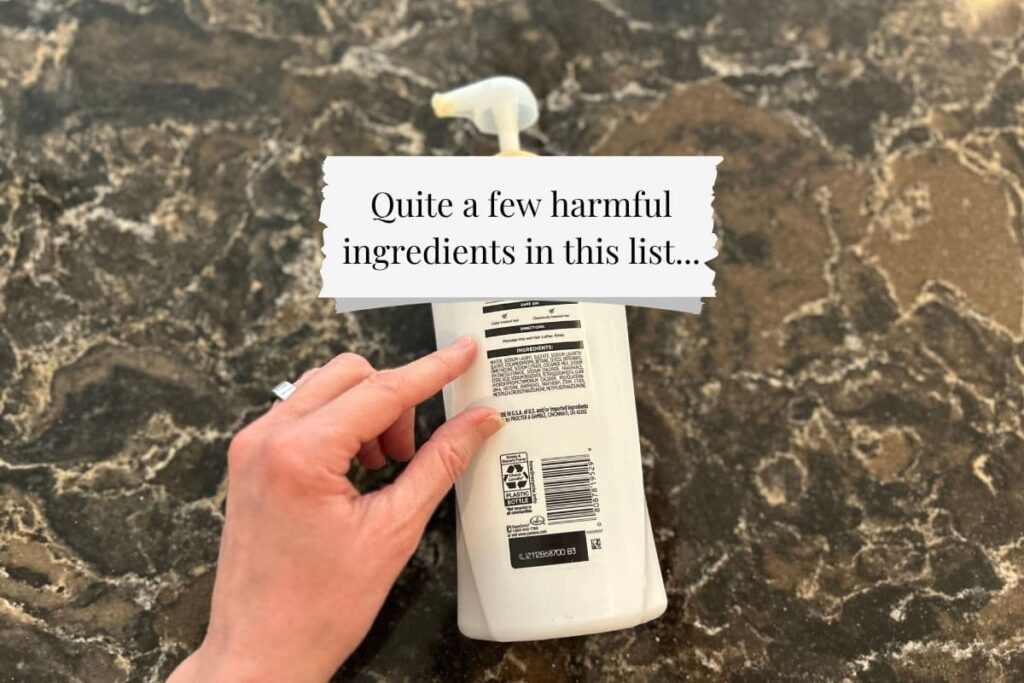 Hand pointing to harmful ingredients on shampoo bottle