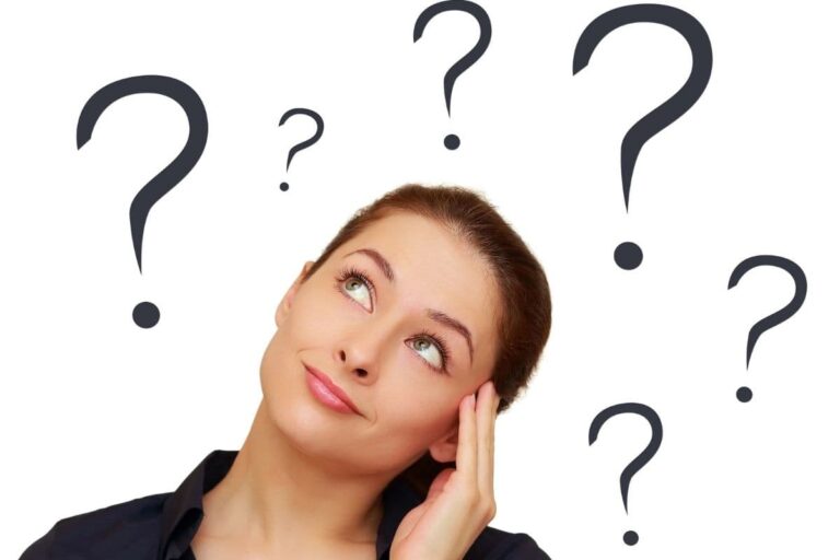Woman thinking with question marks around her head