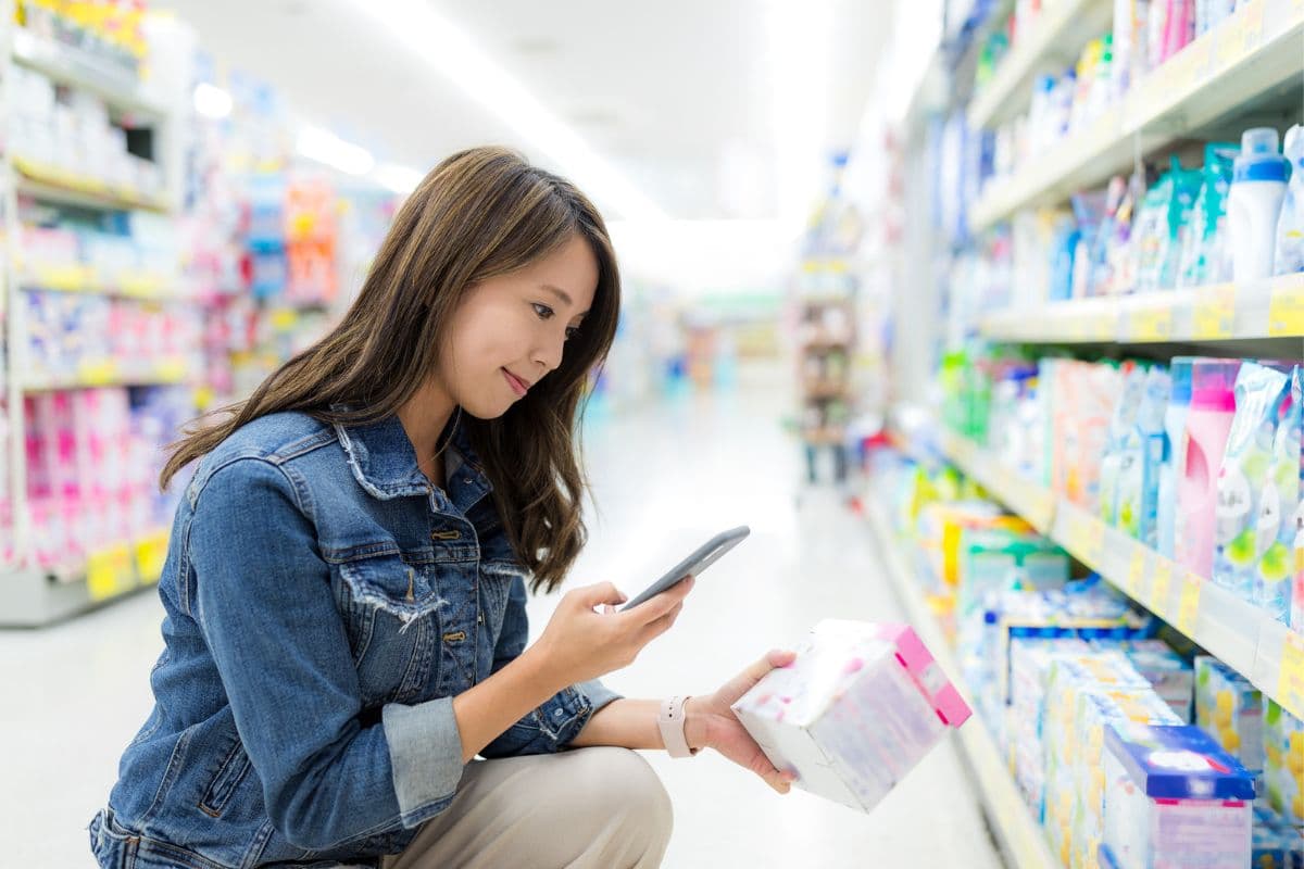 Woman reading ingredient labels at the supermarket
