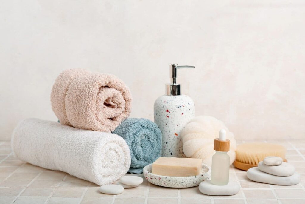 Bathroom supplies, soap, and serum on counter.