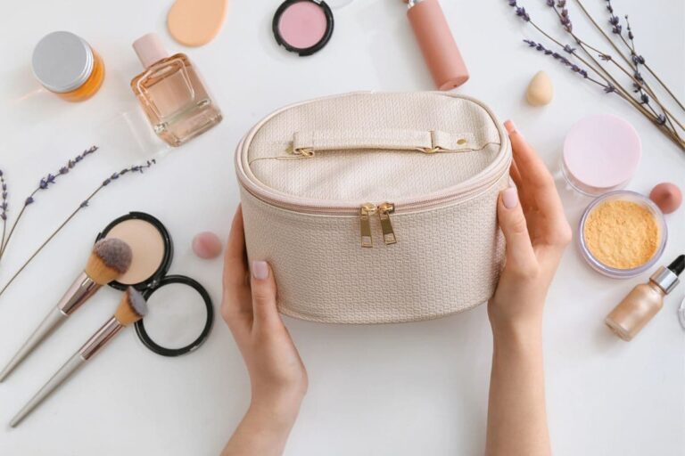 hands holding a beauty bag with clean beauty products and sprigs of lavender on the table