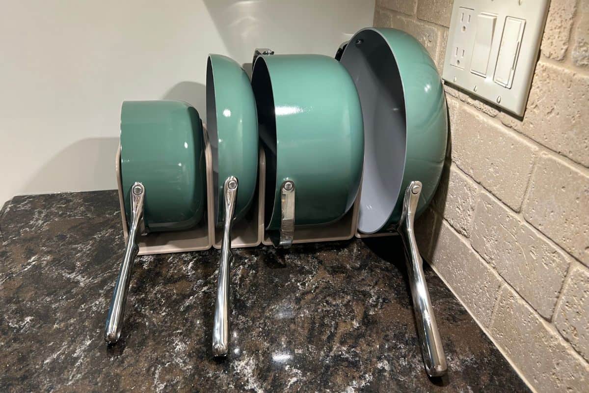 My Caraway 12-piece cookware set in sage green on my countertop.