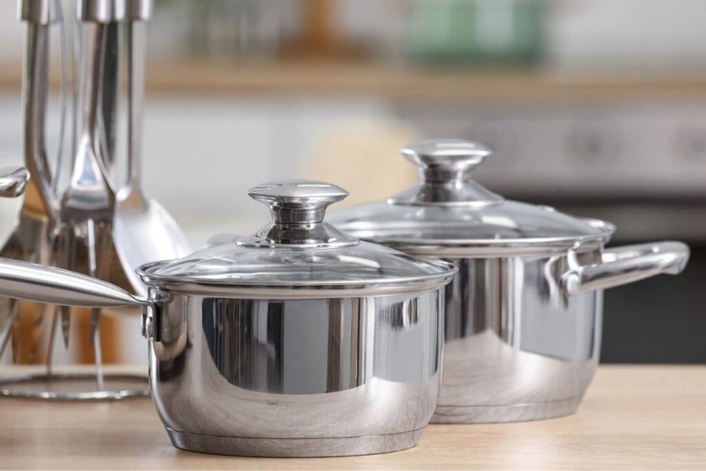 Stainless steel cookware on kitchen counter.