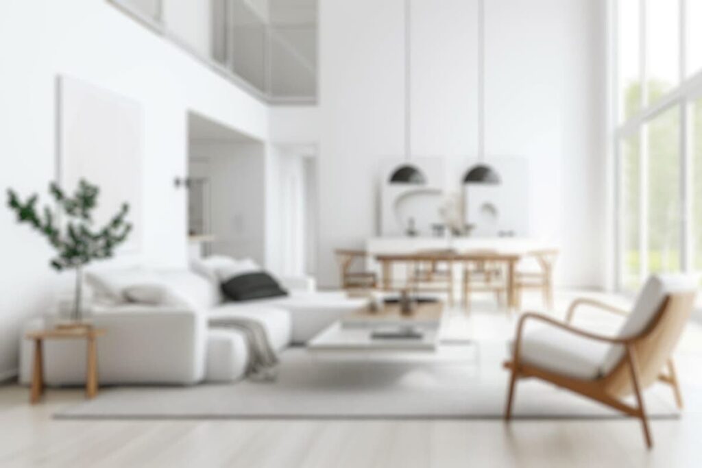 Blurred modern home interior with open floorplan and green plants.