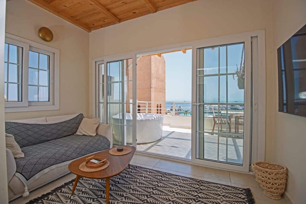 Living room with sliding glass door opened to improve ventilation and reduce VOCs in the home.
