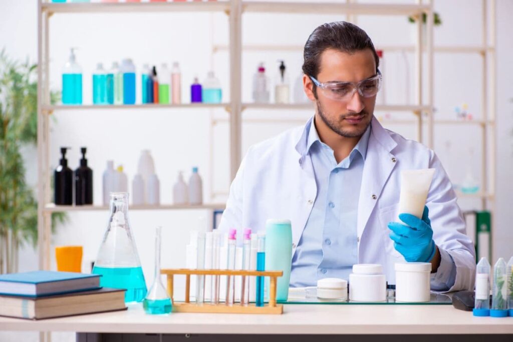 Young male chemist working on skincare ingredients in the lab.