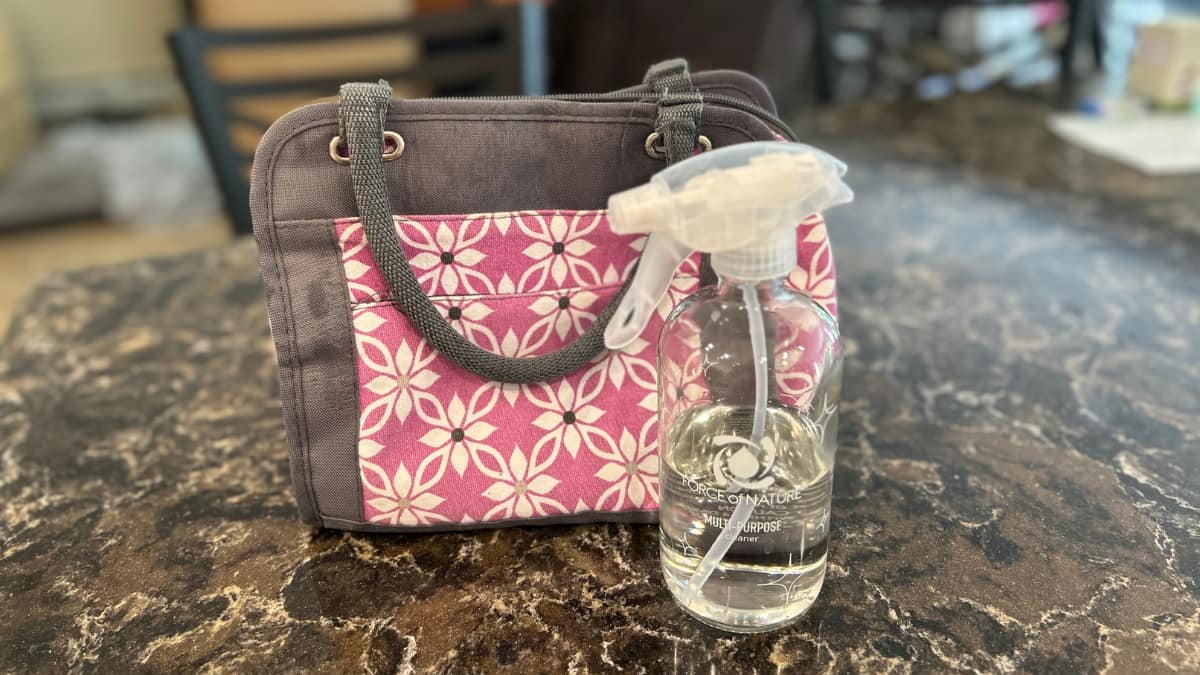 Force of Nature toxin-free cleaning products being used to clean a pink lunchbox during back to school season.